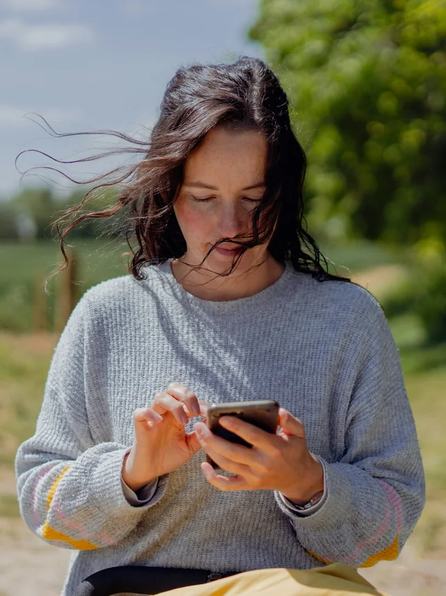 Someone reading their care information on a phone