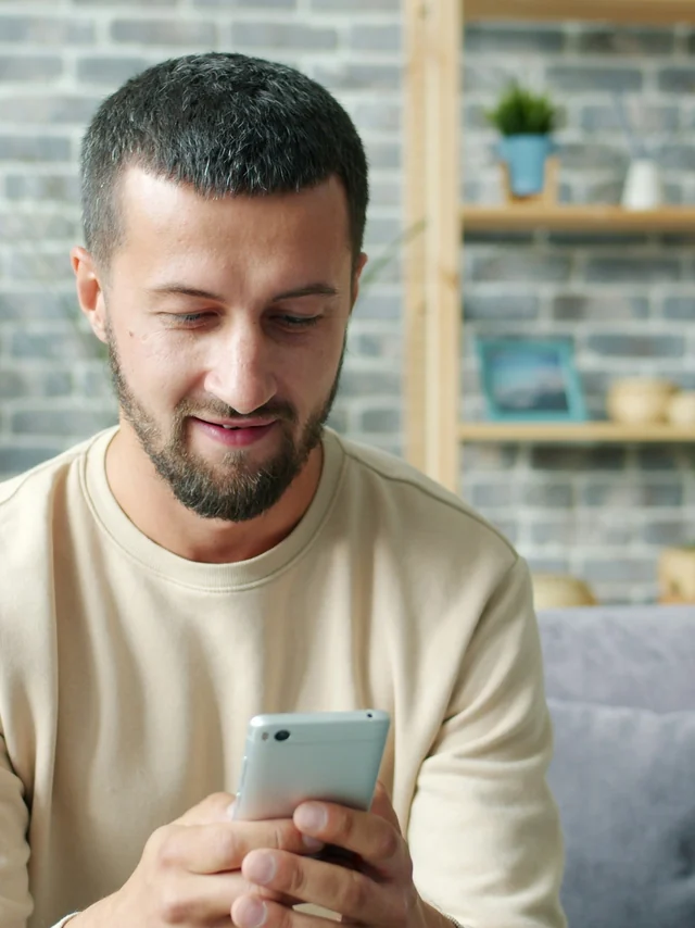 Someone reading their service’s information on a phone at home